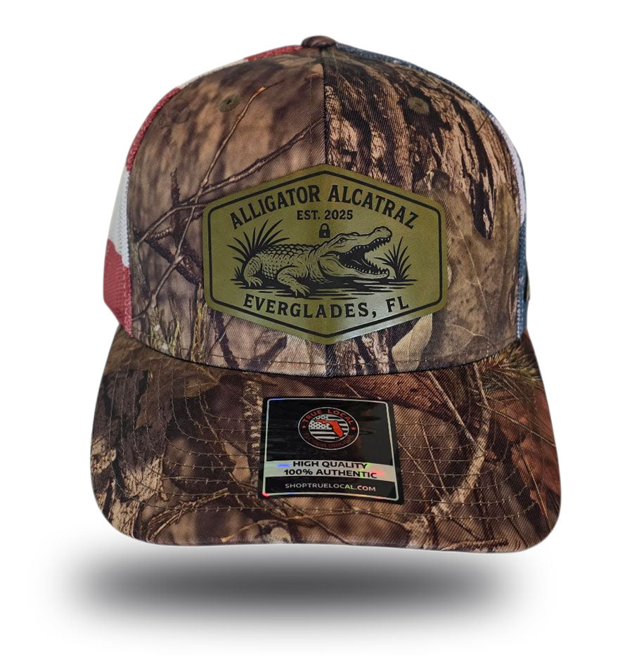 Alligator Alcatraz hat, Everglades trucker hat, Mossy Oak camo cap, stars and stripes hat, leather patch snapback, Florida fishing hat, patriotic trucker hat, camo hunting cap, outdoor adventure hat, True Local brand.
