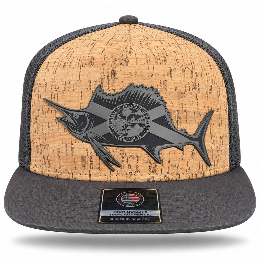 Front of charcoal sailfish cork-finish snapback hat showing Florida flag fish patch, tan textured front and short wide gray flat brim