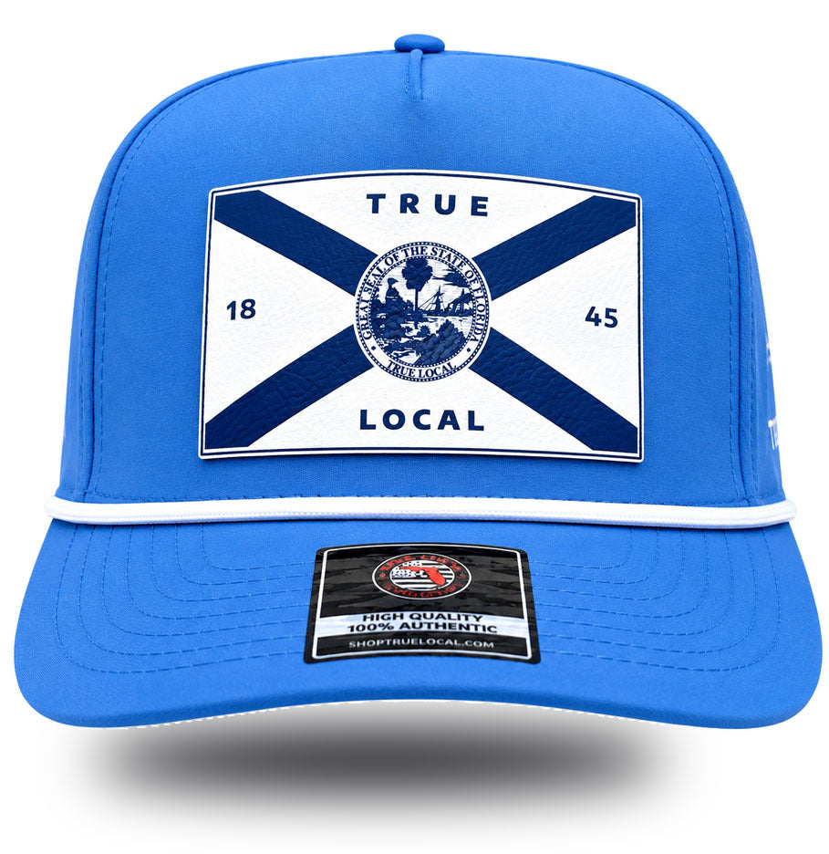 White Florida flag patch with state seal and TRUE LOCAL on sky blue performance rope hat, front view