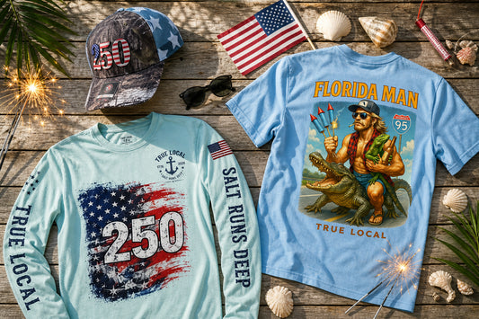 True Local 4th of July Florida gear flat lay — 250th Anniversary hat, patriotic long sleeve, and Florida Man tee