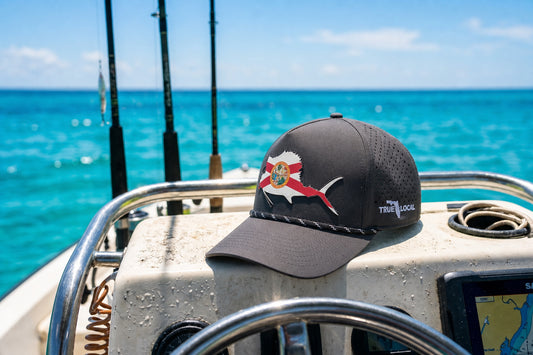 True Local Florida Flag Sailfish Performance Rope Hat on a fishing boat in South Florida