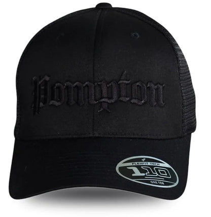 Black Pompton trucker hat with embroidered gothic lettering, mesh back, and Flexfit 110 label