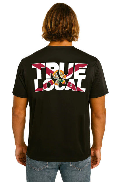 Black True Local t-shirt with bold graphic back print, worn by man with long hair, Florida pride apparel