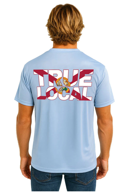 Man wearing light blue True Local t-shirt with bold red and white graphic back design, Florida-themed apparel