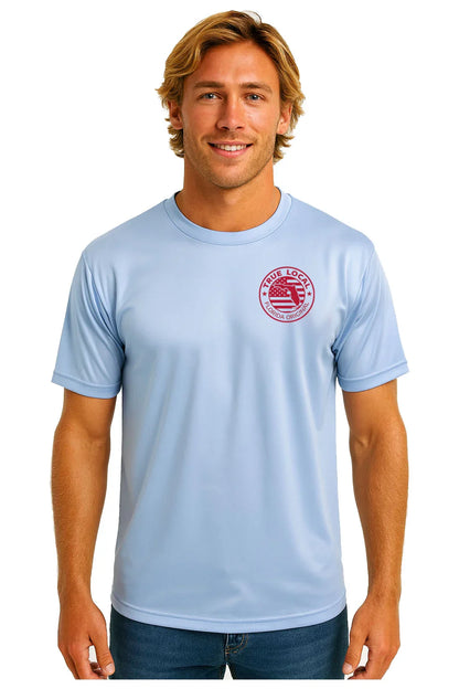 Man wearing light blue Florida pride t-shirt with red 'True Local Florida Original' graphic, celebrating local community spirit.