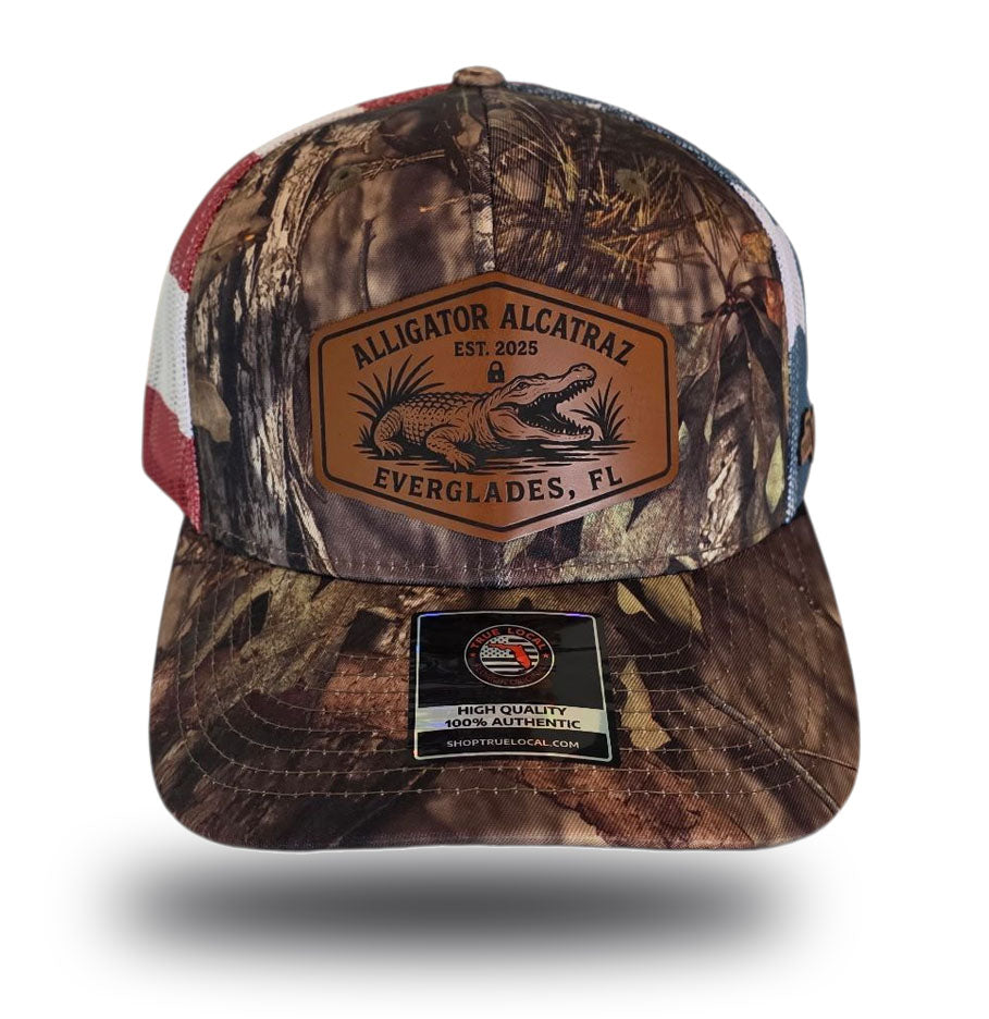Alligator Alcatraz hat, Everglades trucker hat, Mossy Oak camo cap, stars and stripes hat, leather patch snapback, Florida fishing hat, patriotic trucker hat, camo hunting cap, outdoor adventure hat, True Local brand.