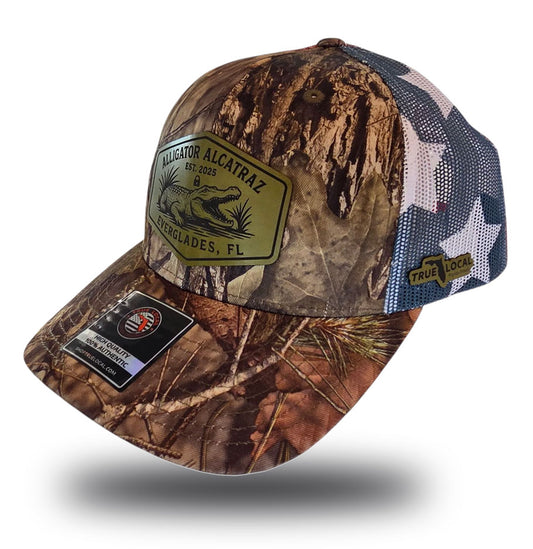 Alligator Alcatraz hat, Everglades trucker hat, Mossy Oak camo cap, stars and stripes hat, leather patch snapback, Florida fishing hat, patriotic trucker hat, camo hunting cap, outdoor adventure hat, True Local brand.