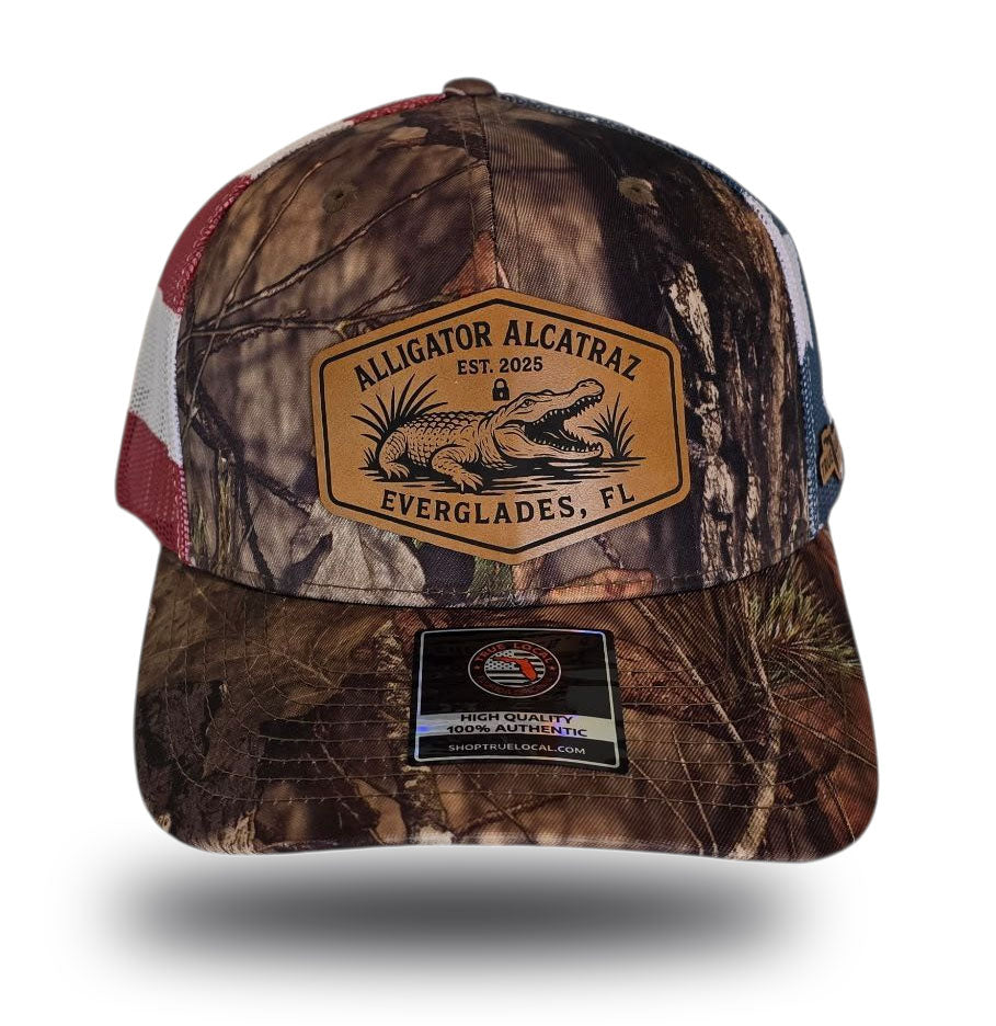 Alligator Alcatraz hat, Everglades trucker hat, Mossy Oak camo cap, stars and stripes hat, leather patch snapback, Florida fishing hat, patriotic trucker hat, camo hunting cap, outdoor adventure hat, True Local brand.
