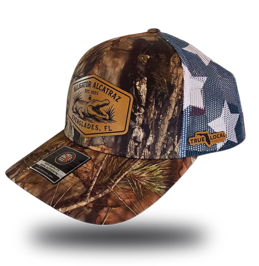 Alligator Alcatraz hat, Everglades trucker hat, Mossy Oak camo cap, stars and stripes hat, leather patch snapback, Florida fishing hat, patriotic trucker hat, camo hunting cap, outdoor adventure hat, True Local brand.