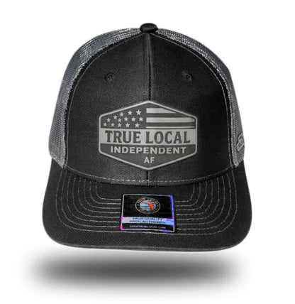 True Local Independent AF trucker hat with USA flag patch, black mesh back, Florida community pride apparel