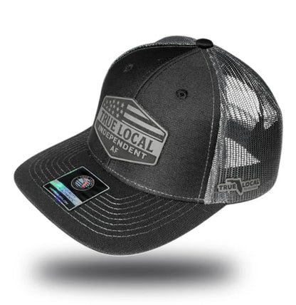 Black trucker hat with 'True Local Independent AF' patch and mesh back, Florida community apparel