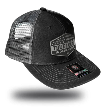 Black trucker hat with 'True Local Independent AF' patch, mesh back, Florida community pride apparel