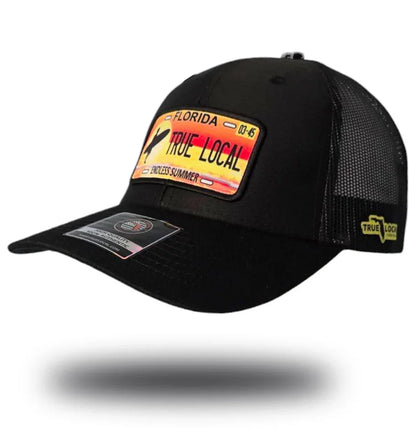 Black trucker hat with Florida license plate patch reading 'True Local Endless Summer', perfect for Florida pride apparel.