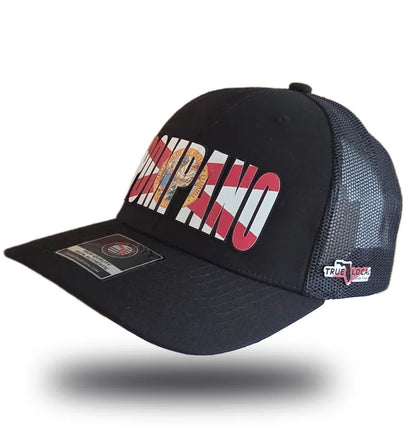 Black Pompano Beach trucker hat with bold red and white lettering, mesh back, and local pride design