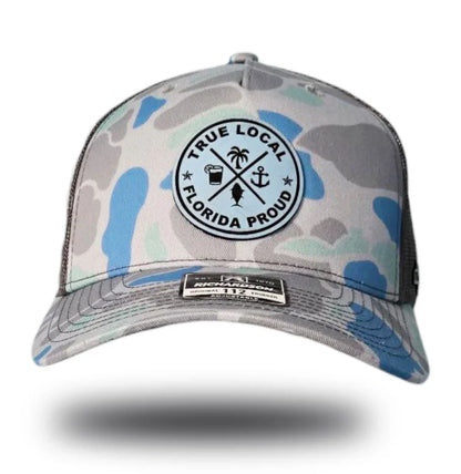 Florida Proud camo trucker hat with True Local patch, palm, anchor, fish design for local pride apparel