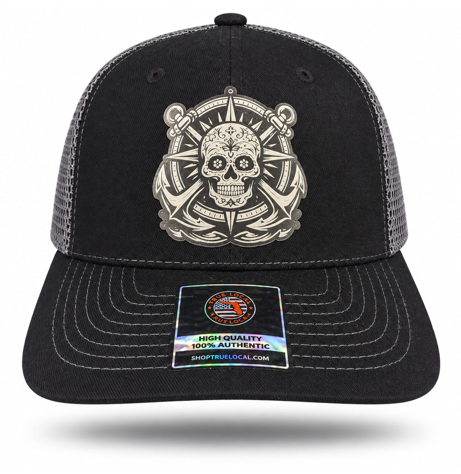 Black and Gray Sugar Skull Anchor Trucker Hat, front view showing sugar skull compass and twin-anchor patch