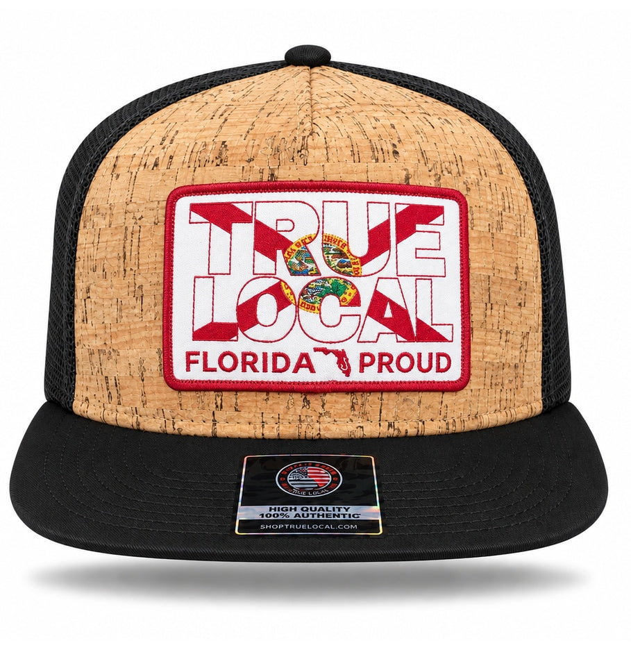 Front of black Florida Proud cork-finish snapback hat showing True Local Florida Proud patch, tan textured front and short wide black flat brim