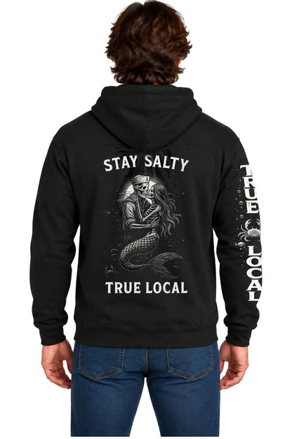 Black Stay Salty hoodie sweatshirt back with skeleton sailor and mermaid embracing under a full moon, Stay Salty and True Local text